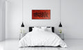 Fire by Alli Cullimore displayed above a bed in a minimalist white room — a wide landscape abstract painting in deep reds and black in a black floating frame, Gallery 68
