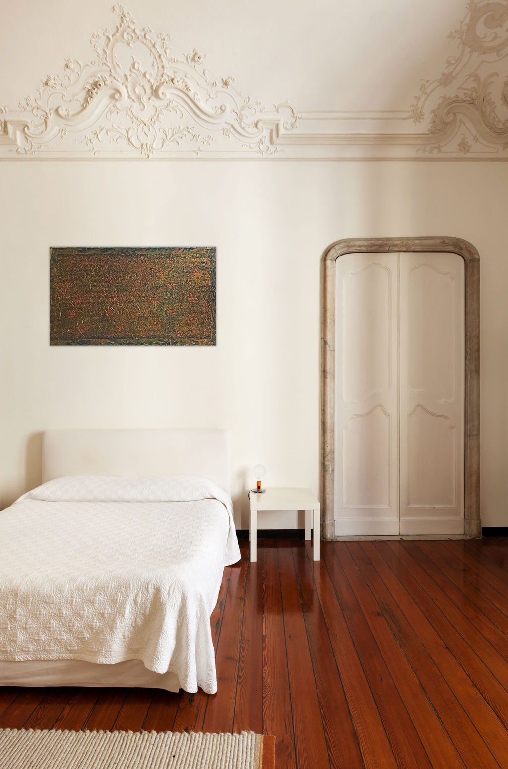 Brushed Copper original textured artwork by Alli Cullimore, displayed on a white wall above a bed in an elegant room with ornate ceiling moulding and hardwood floors