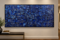Denim original abstract painting by Alli Cullimore displayed in a hallway — 152.5×76cm acrylic on canvas with richly textured lines and squares in deep indigo, navy and cobalt blue with white highlights